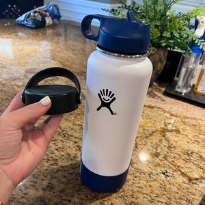 40 oz white hydro flask with navy silicone boot and lid as well as original top